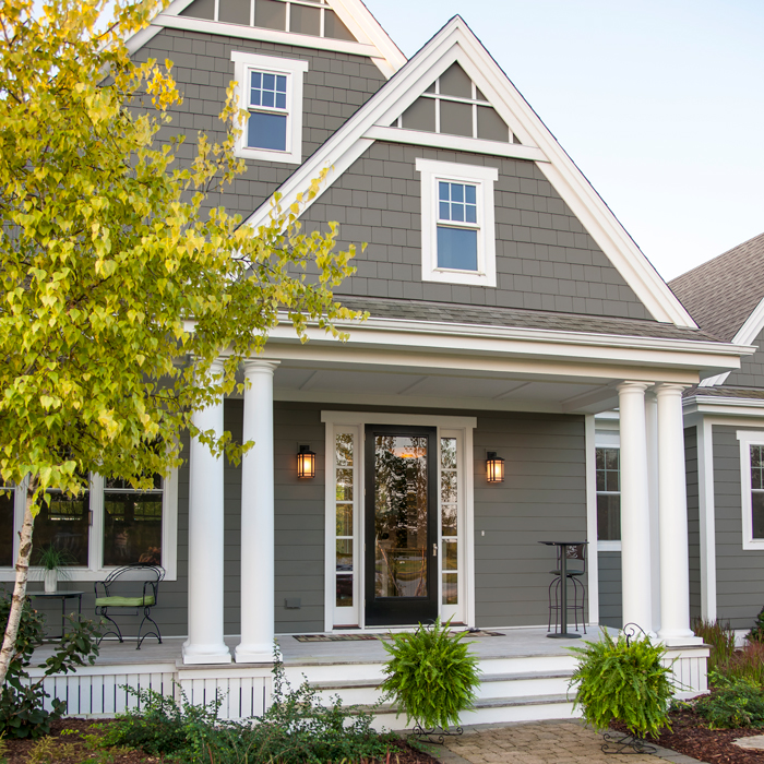 A beautiful house lit up at night with siding and replacement windows from Precision Siding & Windows in Kansas City Missouri